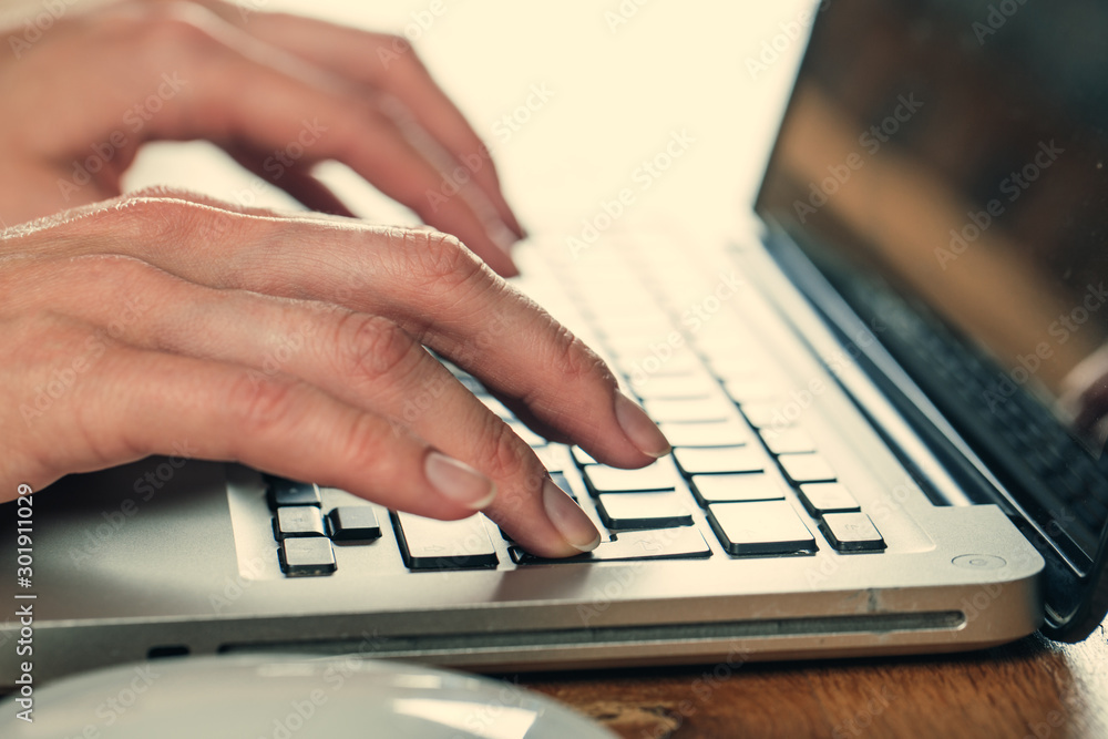 Woman working at home office hand on keyboard close up Woman working at home office hand on keyboard close up