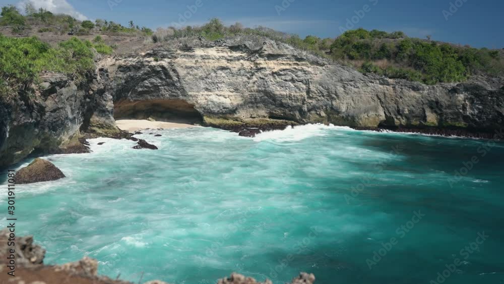 Ocean view to the Devill eye coast formation with blue lazure ocean water. Bali Indonesia Ocean view to the Devill eye coast formation with blue lazure ocean water. Bali Indonesia