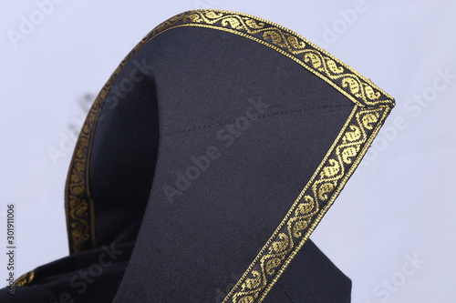 A Malay black coloured with gold lace traditional 