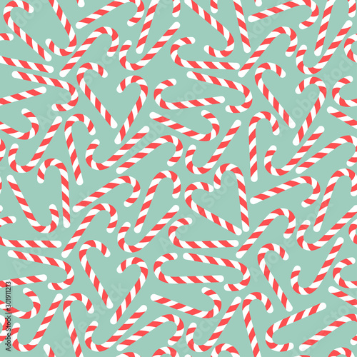 Red candy canes on blue background, winter seamless pattern Vector illustration.