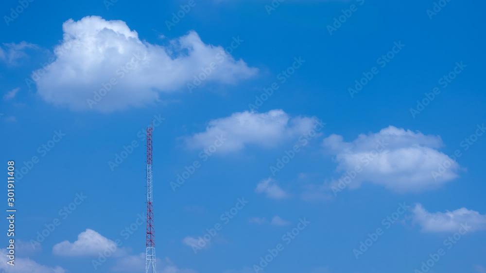 The signal towers have a sky and clouds in the background The signal towers have a sky and clouds in the background