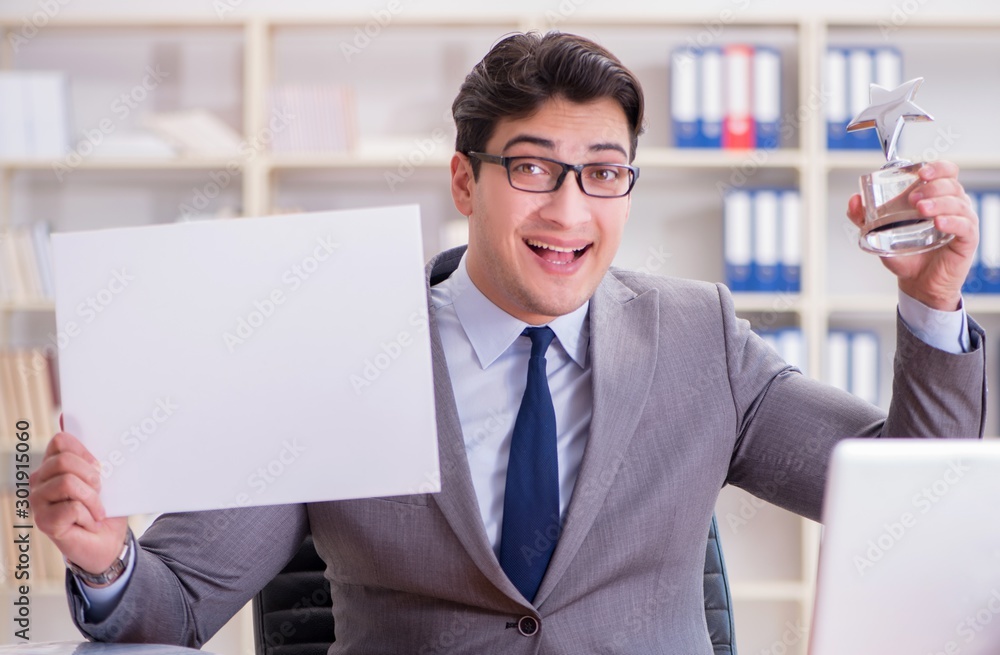 Businessman in office holding a blank message board Businessman in office holding a blank message board