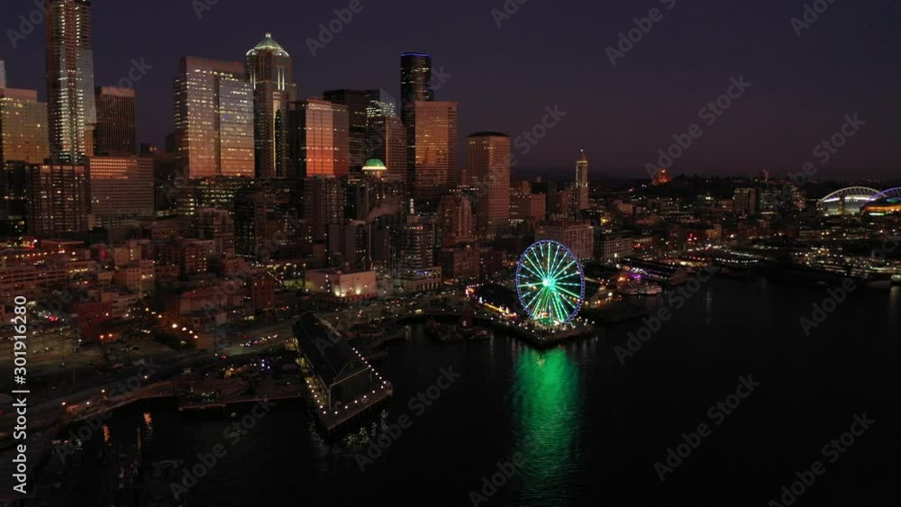 Seattle downtown, waterfront, piers, Alaskan Way with skyscrapers at dusk Seattle downtown, waterfront, piers, Alaskan Way with skyscrapers at dusk
