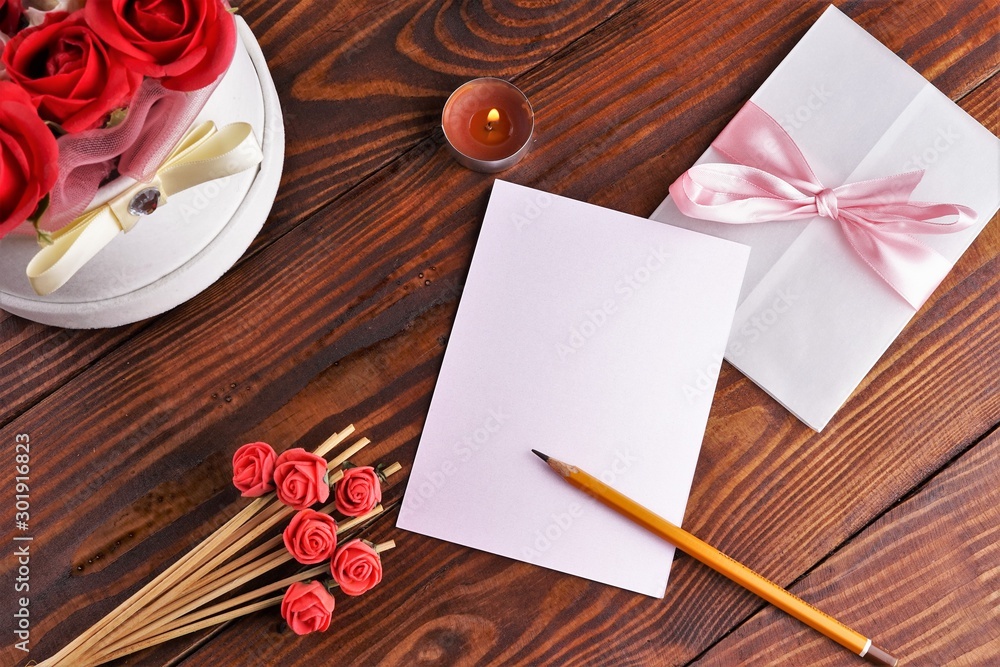 Gift box with flowers on wooden background, preparation for the holiday concept. Top view and copy area for text. Gift box with flowers on wooden background, preparation for the holiday concept. Top view and copy area for text.