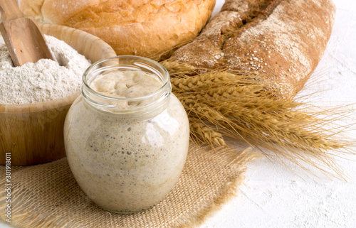 Active rye sourdough in a glass jar for homemade bread.