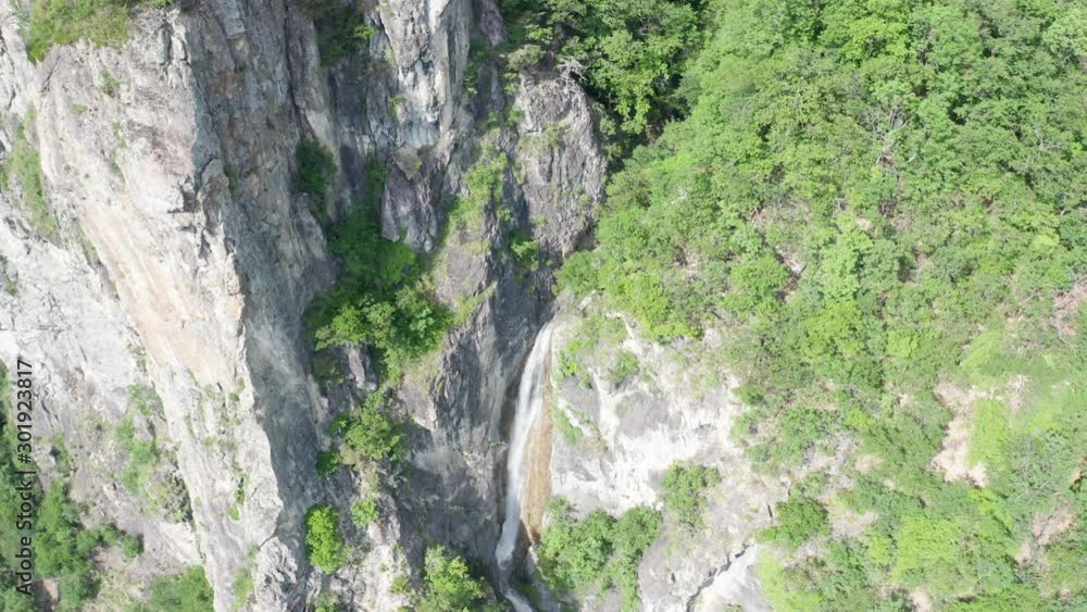 Aerial jib down of small waterfall in the mountains Aerial jib down of small waterfall in the mountains
