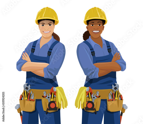 Set of European and African female workers with tools. Cartoon smiling work women, builder wearing safety helmet, coveralls and toolbelt. Vector illustration isolated on the white background