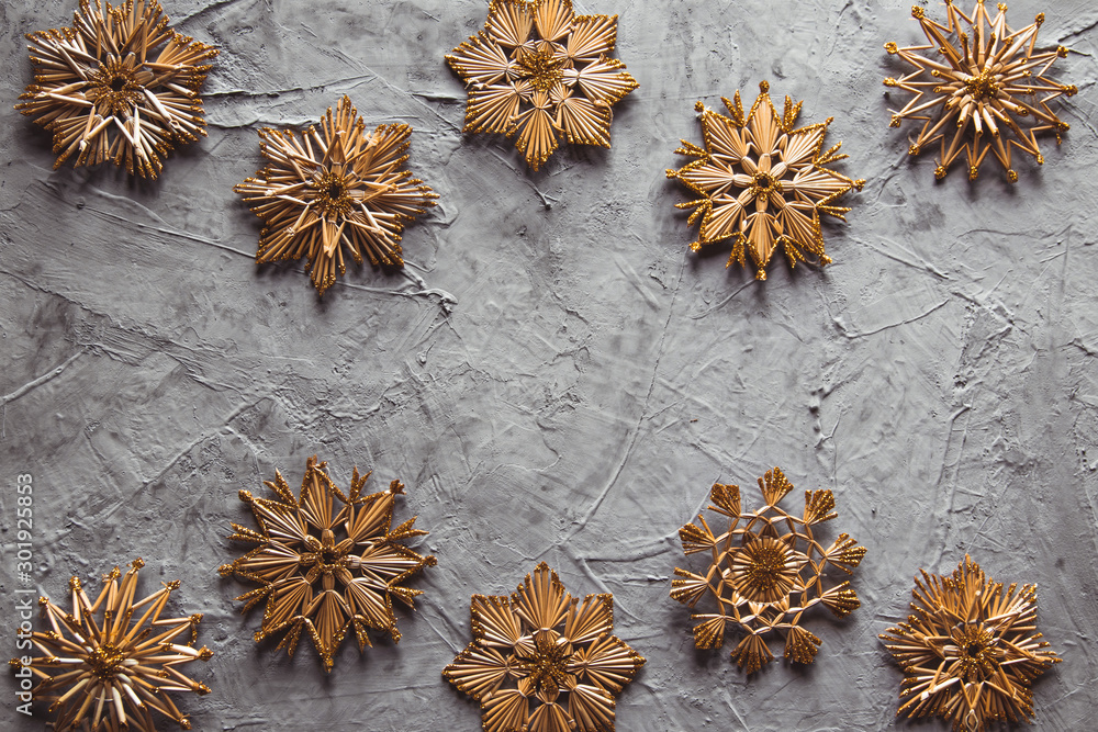New Year's straw toys, on a gray concrete background. Christmas card New Year's straw toys, on a gray concrete background. Christmas card