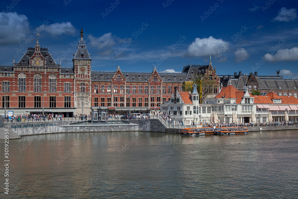 The Centraal Station (Hauptbahnhof), in the foreground a boat pier for canal canal cruises, Amsterdam, Holland, Netherlands The Centraal Station (Hauptbahnhof), in the foreground a boat pier for canal canal cruises, Amsterdam, Holland, Netherlands
