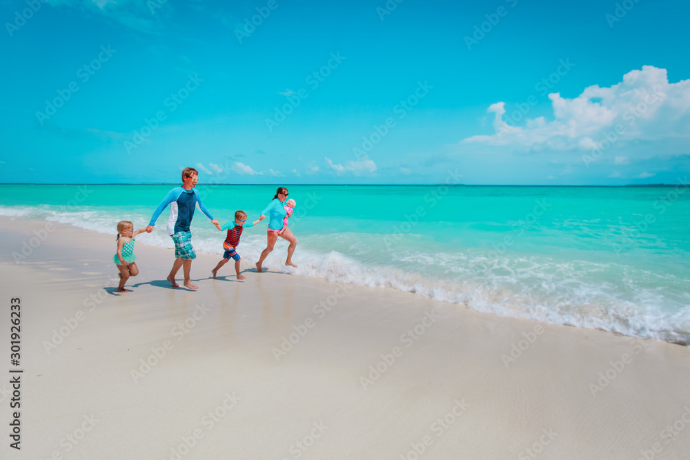 happy family with kids play with water run on beach happy family with kids play with water run on beach