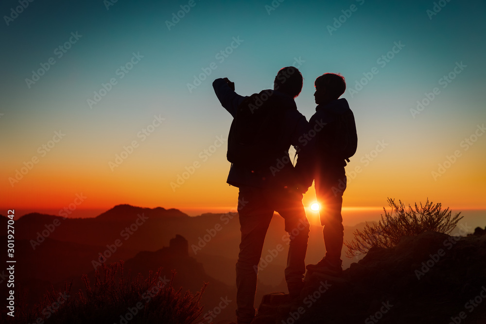 father and son making selfie in mountains, family travel