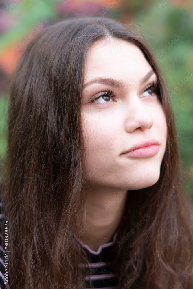 Portrait of a pensive young woman looking up. Portrait of a pensive young woman looking up.