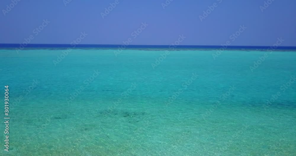 Turquoise wide lagoon bordered by deep blue ocean horizon under purple sky in Cook islands, copy space Turquoise wide lagoon bordered by deep blue ocean horizon under purple sky in Cook islands, copy space