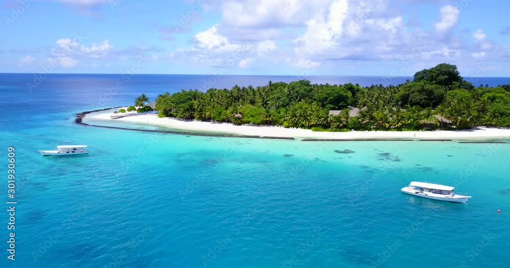 Beautiful vacation day on exotic island surrounded by turquoise lagoon with tourists boats anchored in Fiji islands Beautiful vacation day on exotic island surrounded by turquoise lagoon with tourists boats anchored in Fiji islands