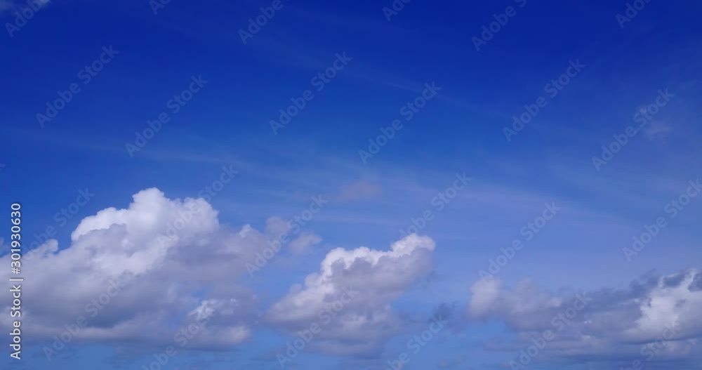 Beautiful clouds moving slowly on blue sky creating a peaceful feeling, inspirational copy space Beautiful clouds moving slowly on blue sky creating a peaceful feeling, inspirational copy space