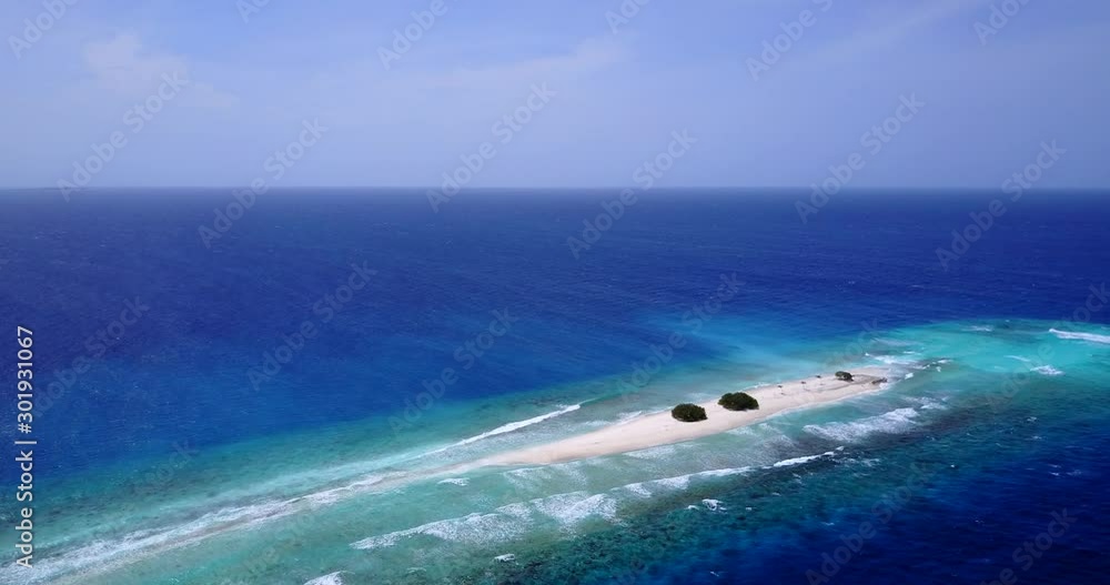 A Small White Island In Bahamas Surrounded By The Deep Blue Water Under The Foamy Sky - Aerial Shot A Small White Island In Bahamas Surrounded By The Deep Blue Water Under The Foamy Sky - Aerial Shot