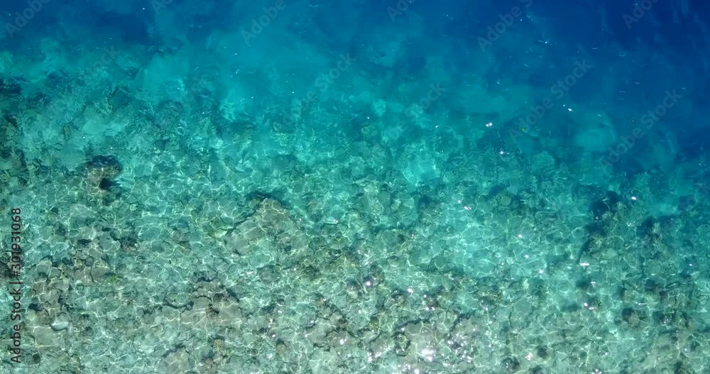 The Clean, Transparent Shallow Waters Of Papua New Guinea On A Bright Sunny Day - Medium Tilt Down Shot The Clean, Transparent Shallow Waters Of Papua New Guinea On A Bright Sunny Day - Medium Tilt Down Shot