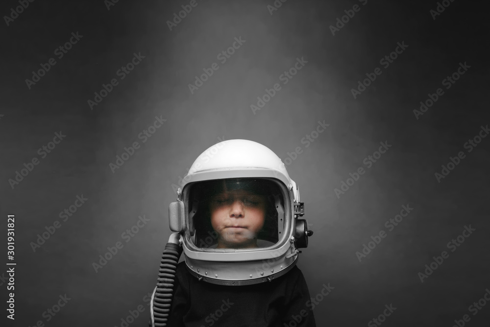 Small child wants to fly an airplane wearing an airplane helmet Small child wants to fly an airplane wearing an airplane helmet