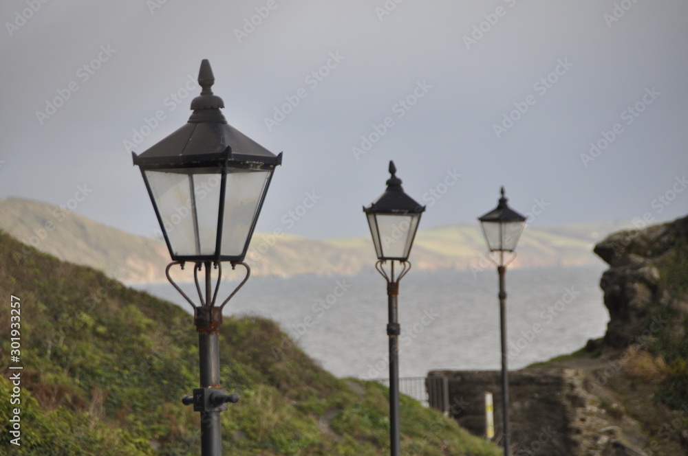 3 old street lamps on cloudy sky