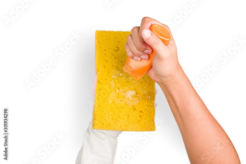 Close up of Hand is wearing the glove and holding a yellow sponge while pouring the cleaning solution, Isolated background with clipping path.