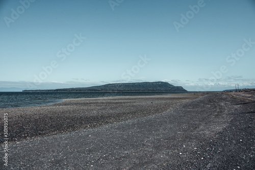 Denman Island, Vancouver Island, British Columbia, Canada: tgravel sand, petroleum blue sea and sky. photo