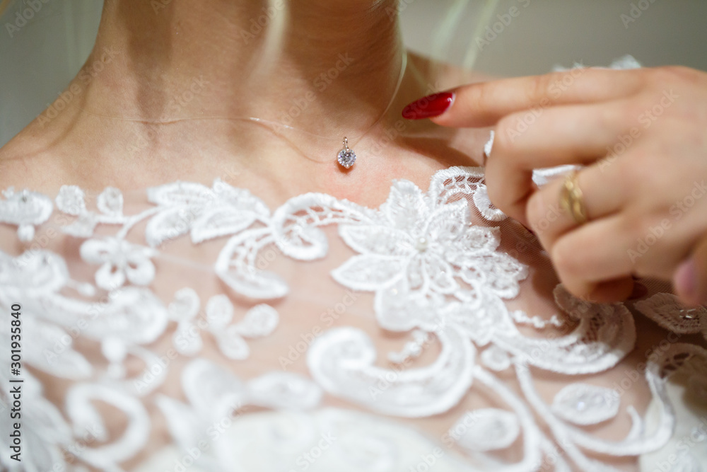 bride puts on wedding jewelry on the wedding day bride puts on wedding jewelry on the wedding day