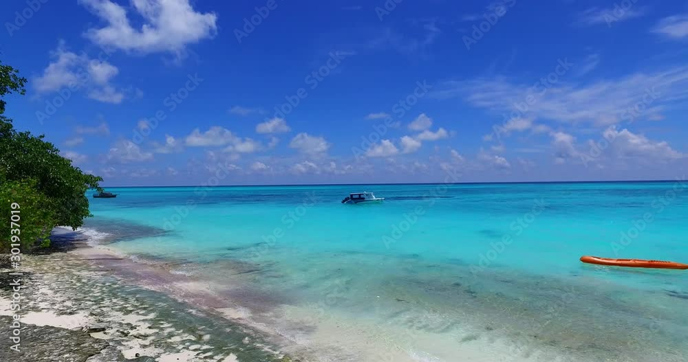 Beautiful Island of Bora Bora In French Polynesia - Waves Travelling On The Shore, Rubber Boat On The Turquoise Sea Waters - Close-up Shot Beautiful Island of Bora Bora In French Polynesia - Waves Travelling On The Shore, Rubber Boat On The Turquoise Sea Waters - Close-up Shot