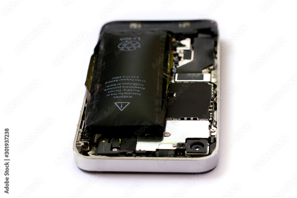 Swollen lithium ion polymer battery inside a mobile phone on white background isolated Swollen lithium ion polymer battery inside a mobile phone on white background isolated