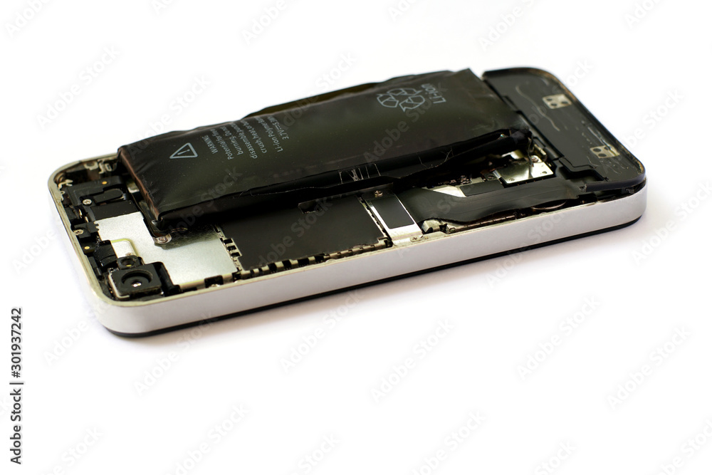 Swollen lithium ion polymer battery inside a mobile phone on white background isolated Swollen lithium ion polymer battery inside a mobile phone on white background isolated