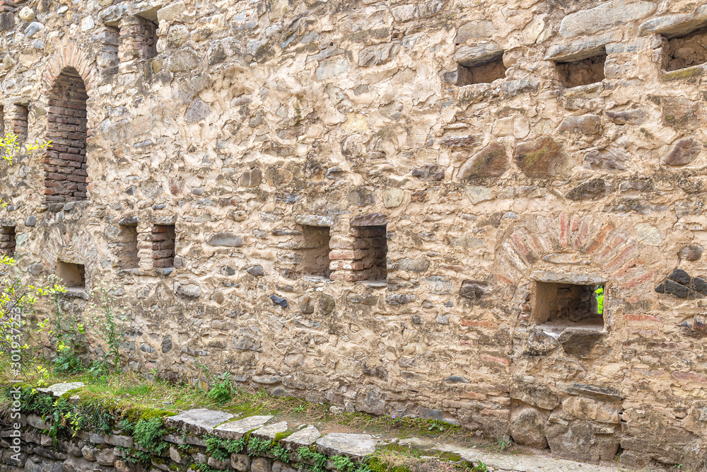 Ancient medieval fortress wall with loopholes