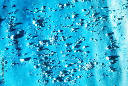 Abstract strokes of watercolor blue paint with crystals for background 