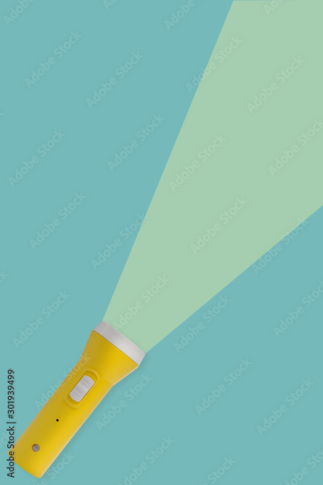 Yellow flashlight on a blue background with copy space. Yellow flashlight on a blue background with copy space.