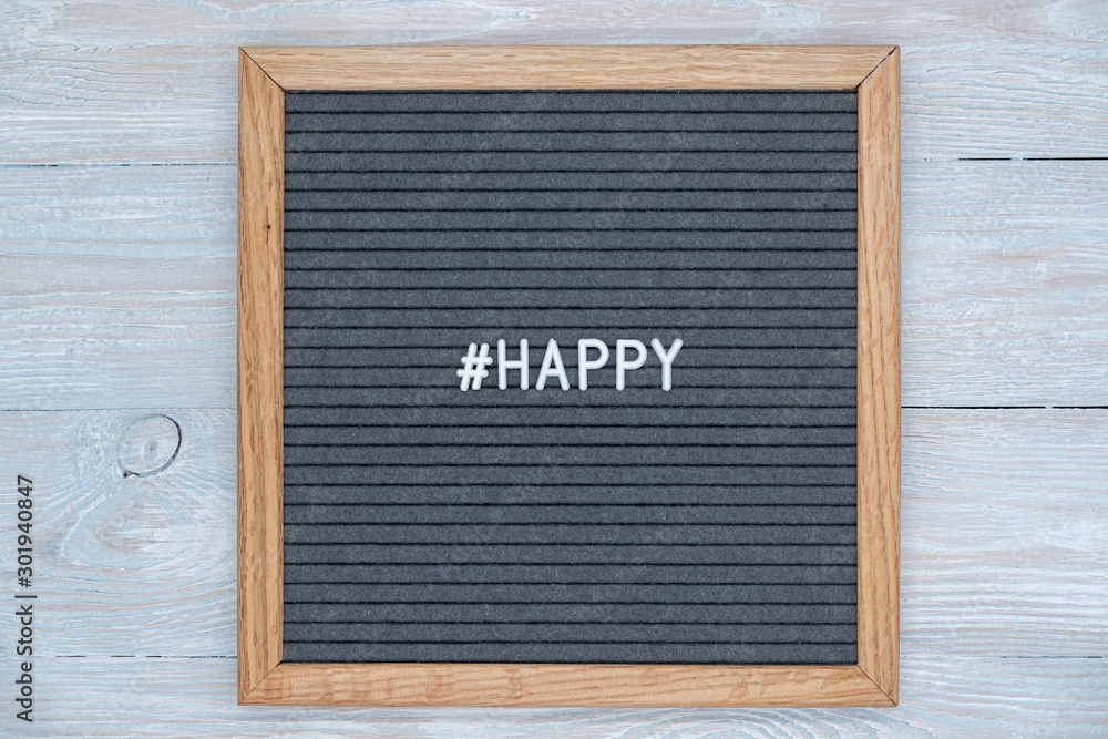 gray felt Board letters with the English word happy and the sign of the hashtag
