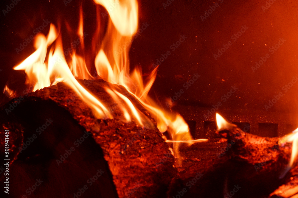 Burning logs in an indoor fireplace