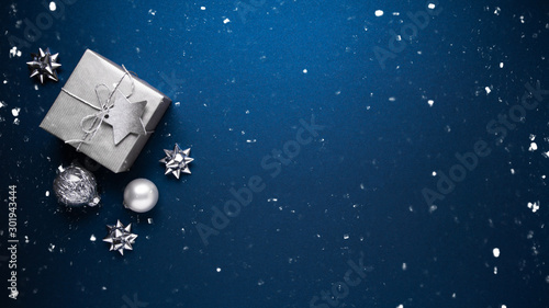 Merry Christmas ornaments and gift on blue background top view. Xmas and new year holiday theme. Flat lay