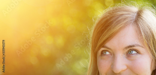 Cutout portrait close up of young beautiful blonde woman with blue eyes outdoors in the park photo