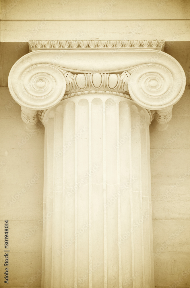 Detail close-up of the capital of a Greek Revival Ionic column in white marble featuring classical volute scrolling atop a fluted shaft Detail close-up of the capital of a Greek Revival Ionic column in white marble featuring classical volute scrolling atop a fluted shaft