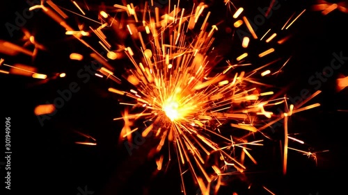 Wallpaper Mural One bright bengal light burns on the black background close-up. Traditional festive christmas pyrotechnics Torontodigital.ca