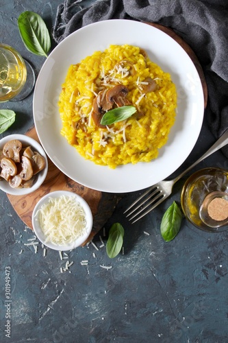 Traditional Italian risotto with mushrooms, saffron and parmesan cheese. Top view with copy space.