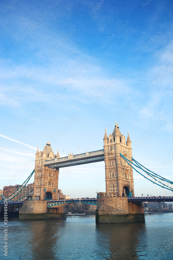 Scenic daytime view of Tower Bridge crossing the River Thames in London under bright blue sky