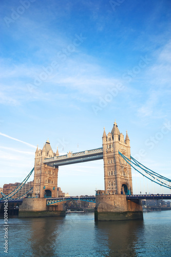 Scenic daytime view of Tower Bridge crossing the River Thames in London under bright blue sky