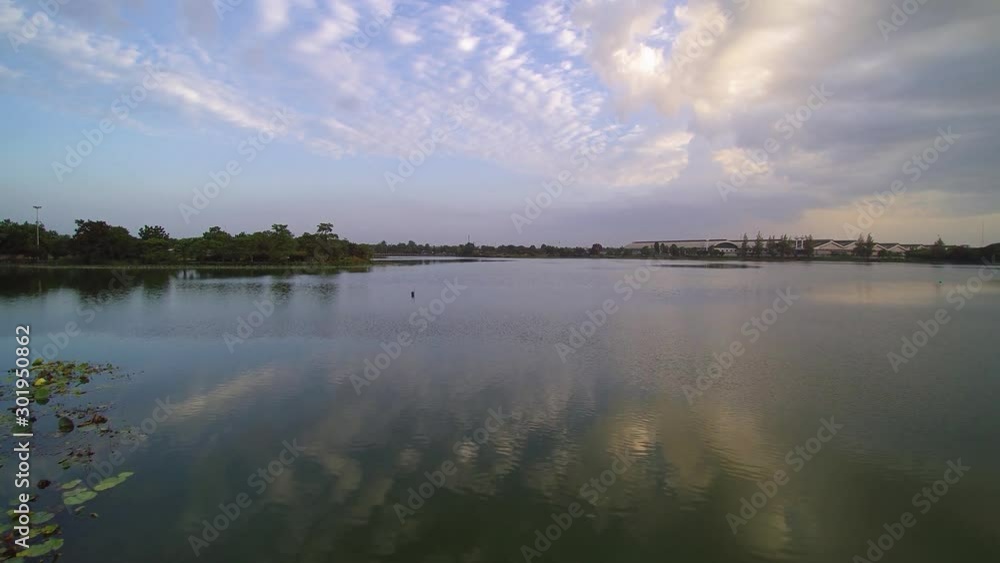 Vdo. Aerial view evening above reservoir around with green tree and cloudy sky background, Krajub reservoir, Nong Kob, Ban Pong, Ratchaburi, Thailand. Vdo. Aerial view evening above reservoir around with green tree and cloudy sky background, Krajub reservoir, Nong Kob, Ban Pong, Ratchaburi, Thailand.