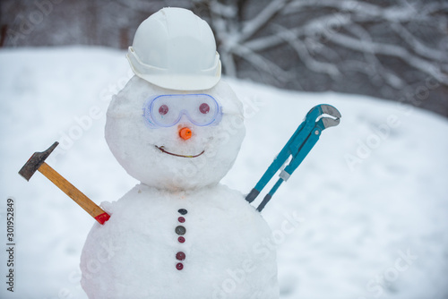 Fototapeta Snowman worker on snow background