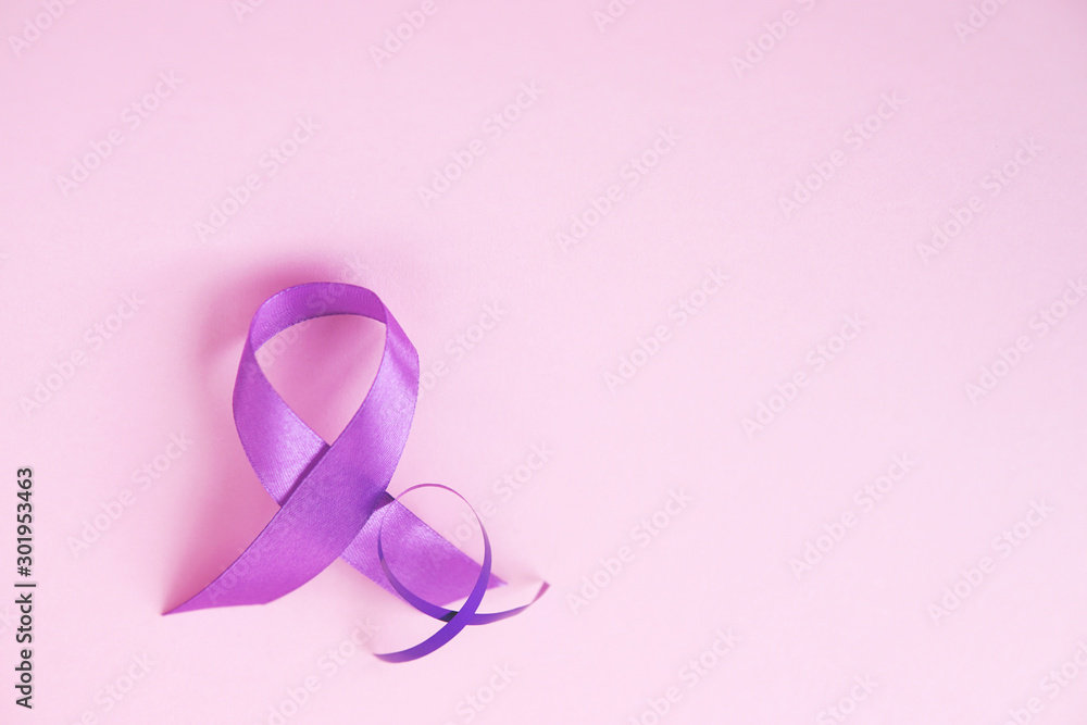 Two purple ribbons on pink paper background. Alzheimer's disease, Pancreatic cancer, Epilepsy awareness, hope, world cancer day. Top view, copy space. Selective focus. Two purple ribbons on pink paper background. Alzheimer's disease, Pancreatic cancer, Epilepsy awareness, hope, world cancer day. Top view, copy space. Selective focus.