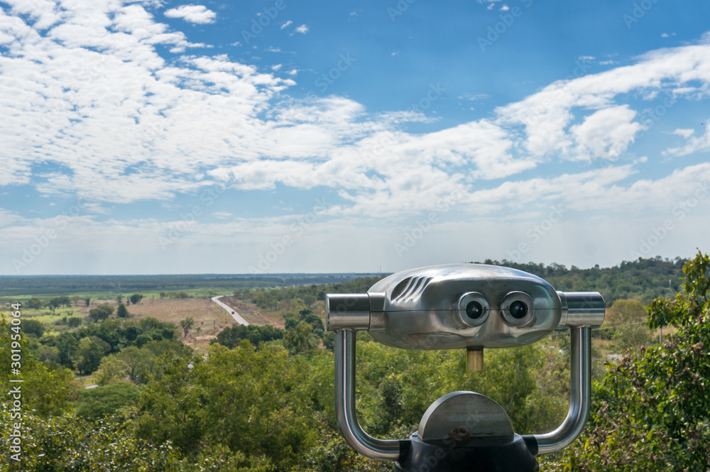 Metal tourist vista binoculars with view of wetlands and eucalyptus forest