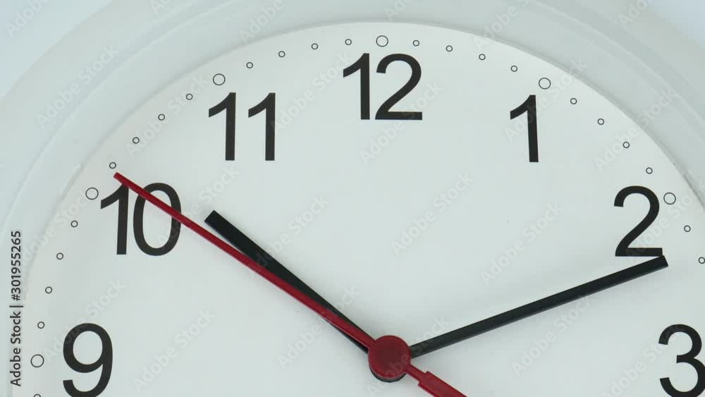 Close up Move the camera angle from left to right, White watch face beginning time 10.12 am or pm , the second hand moves slowly, Time concept. Close up Move the camera angle from left to right, White watch face beginning time 10.12 am or pm , the second hand moves slowly, Time concept.