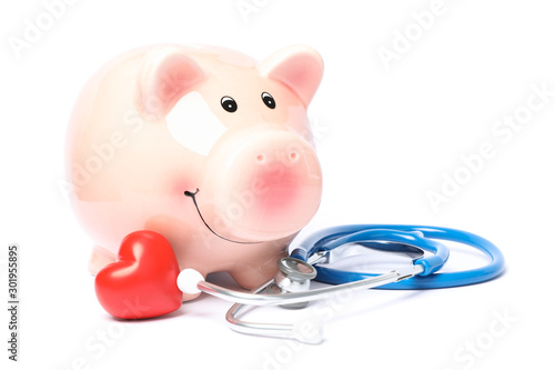 Stethoscope and piggy bank isolated on white background