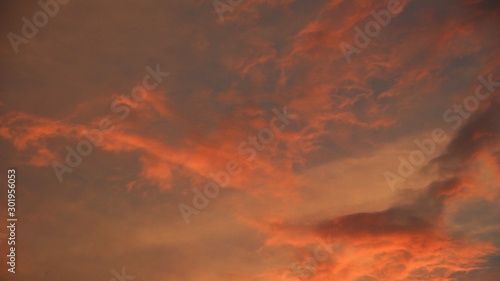 Fototapeta Naklejka Na Ścianę i Meble -  The orange dusk sky with a slight lay of white, gives the impression of a unique fantasy