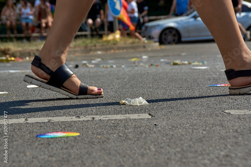 Walking past the trash on the street, condom in the road after gay pride event in Berlin