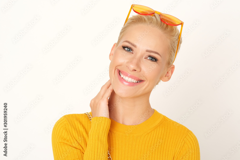 Portrait of beautiful blonde woman in yellow sweater. Portrait of beautiful blonde woman in yellow sweater.